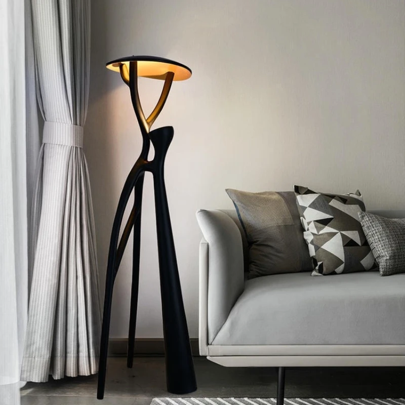 Elegant black LED floor lamp in a cozy living room setting, showcasing its stylish design.