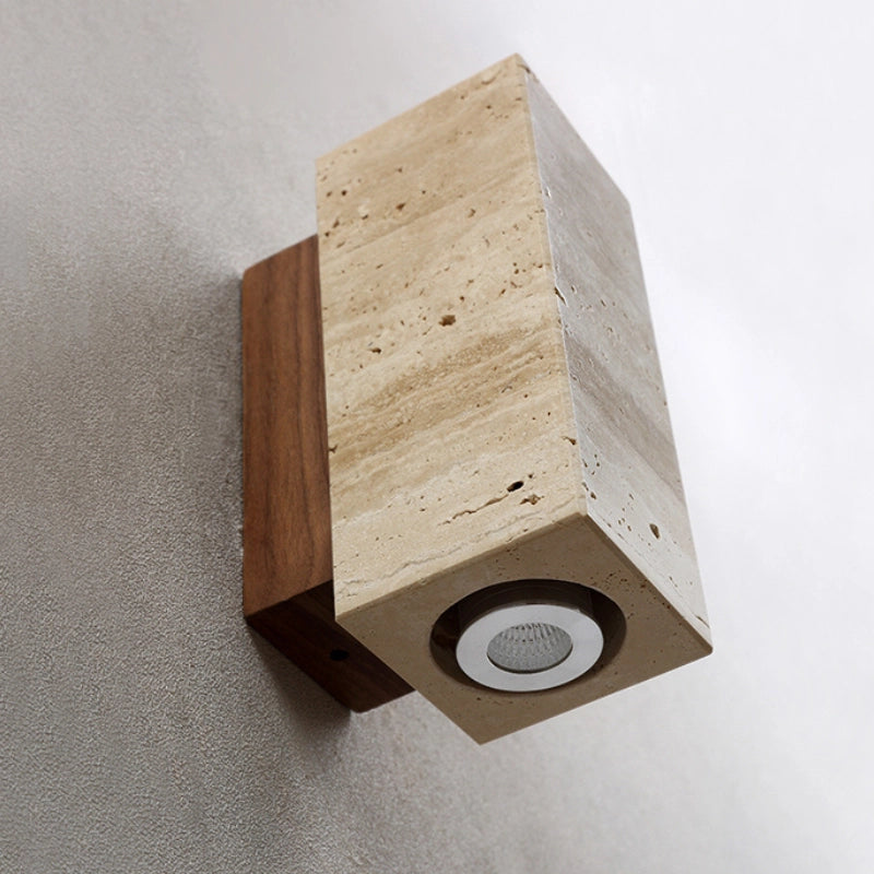 Elegant Japanese travertine wall lamp illuminated in a cozy outdoor setting, enhancing the ambiance.