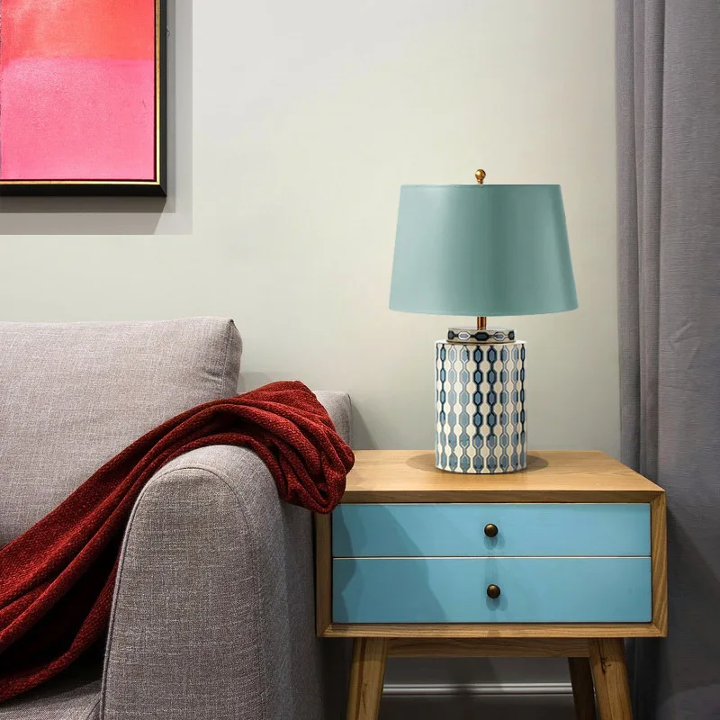 Elegant green ceramic table lamp showcasing geometric design and fabric shade.