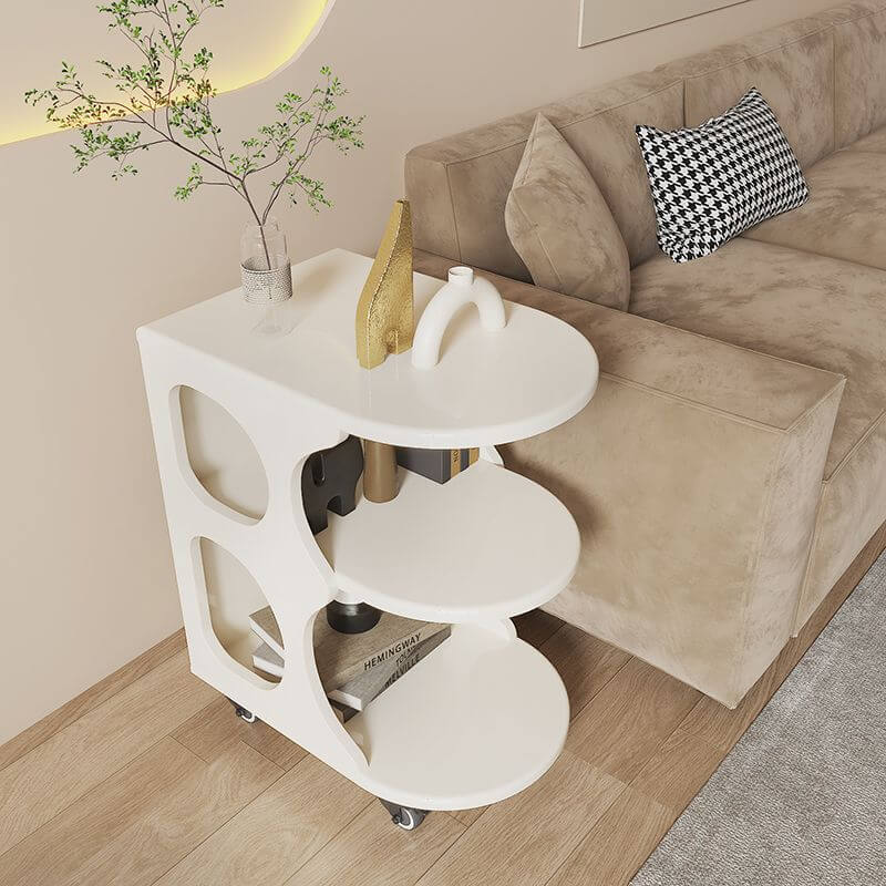 The mobile trolley table with wheels positioned next to a sofa, demonstrating its use as a stylish coffee table.