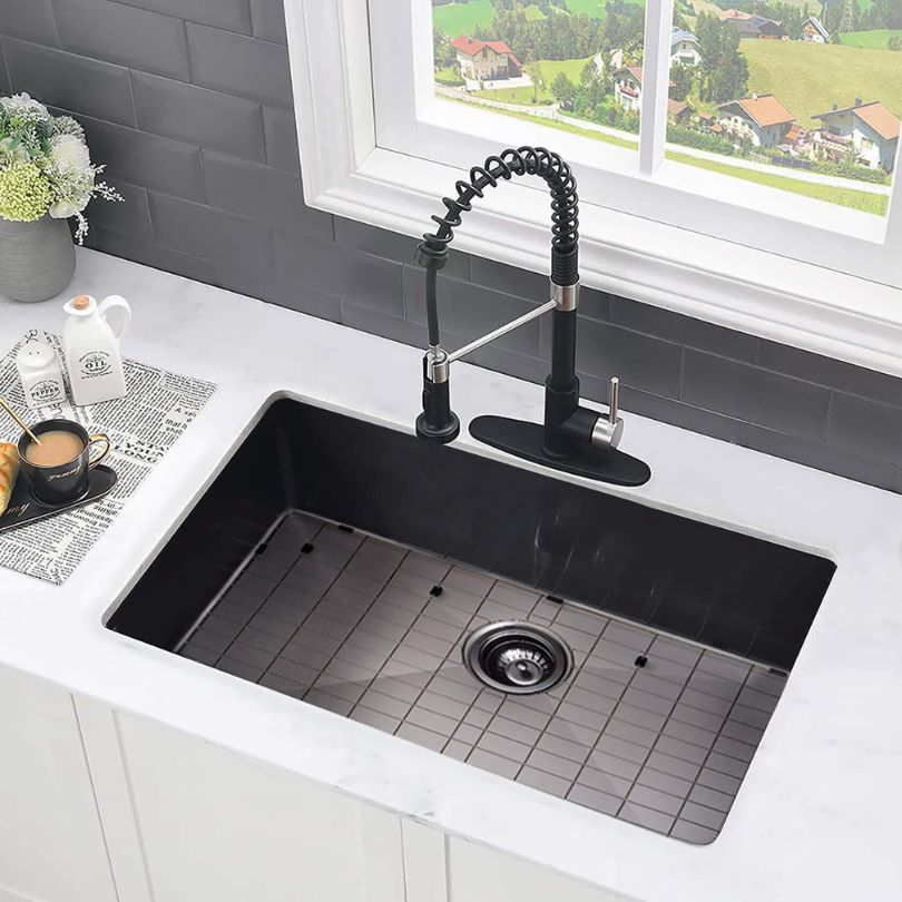 Elegant view of the 30-inch black stainless steel undermount kitchen sink with protective grid.
