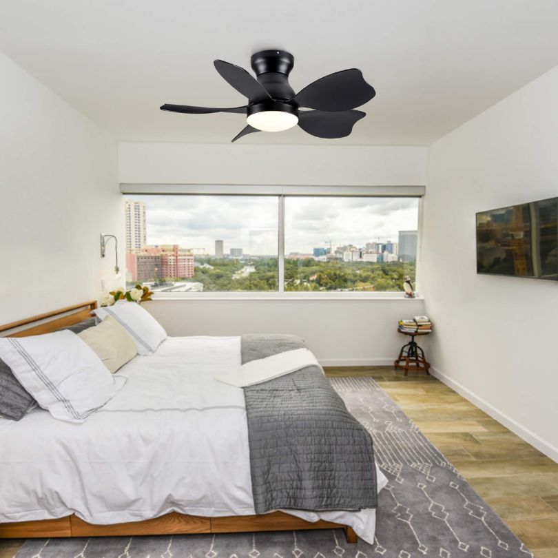 Side view of modern black flush mount ceiling fan with light in a living room.