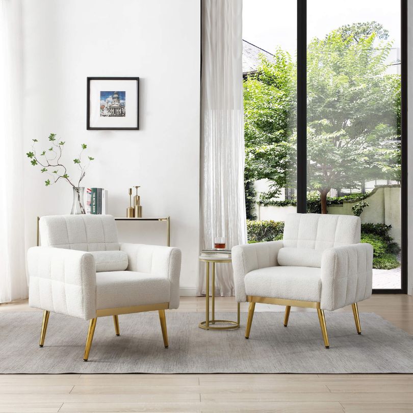 Side angle of affordable mid-century armchair with pillow on light wood floor