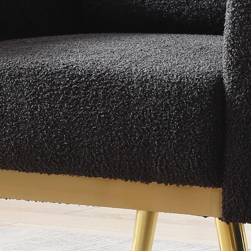 Side angle of the modern armchair showcasing its gold metal legs.