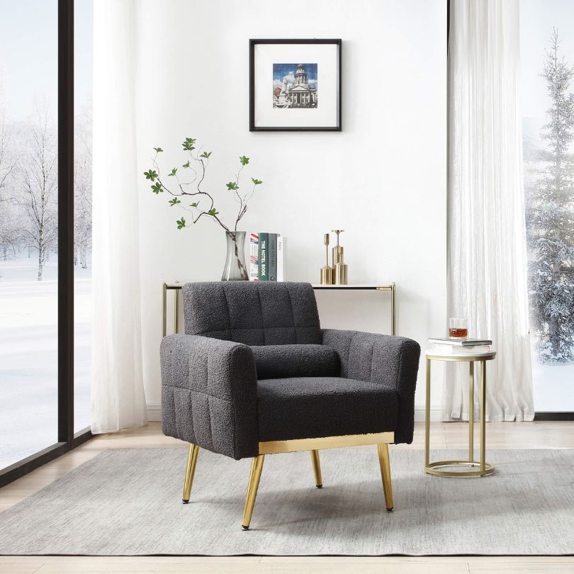 Side angle of the modern armchair showcasing its gold metal legs.