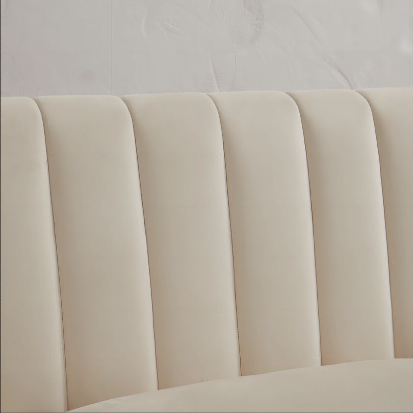 Elegant white tufted barrel accent chair showcasing sleek design from the side