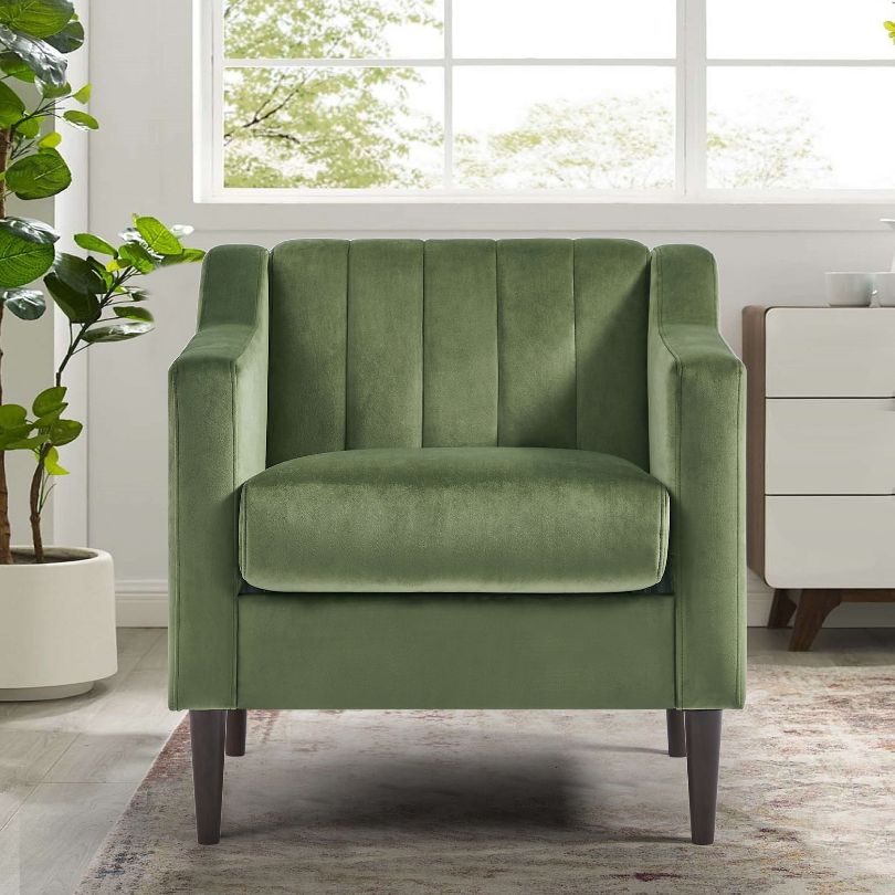 Elegant green tufted barrel accent chair in a cozy living room setting.