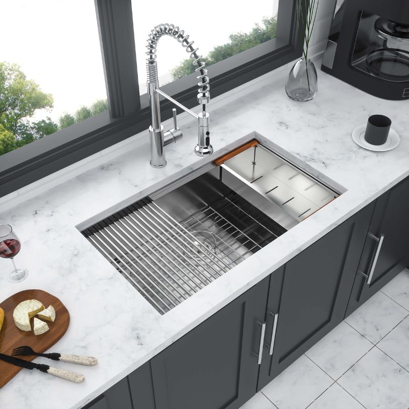 Lifestyle image of the workstation sink in a modern kitchen, highlighting its integrated cutting board and drying rack.