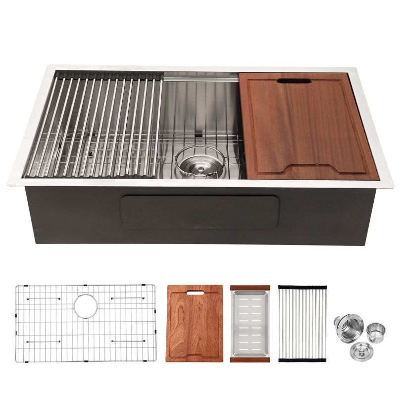 Close-up of the stainless steel single bowl sink displaying the bottom grid and strainer accessories included.