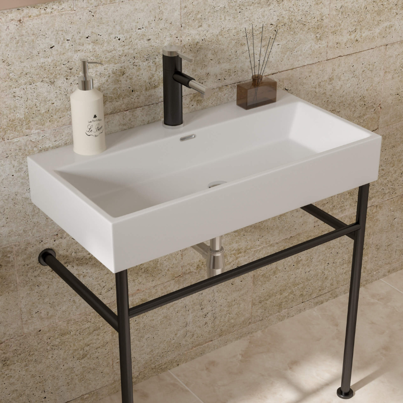 Close-up of the ceramic sinks white finish and black legs, highlighting its stylish design.