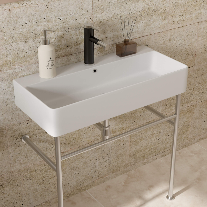 Front view of ceramic console sink showcasing overflow and polished silver legs