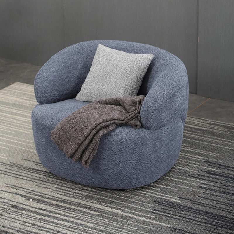 Side view of the blue fabric mid-century swivel sofa showcasing its curved design.