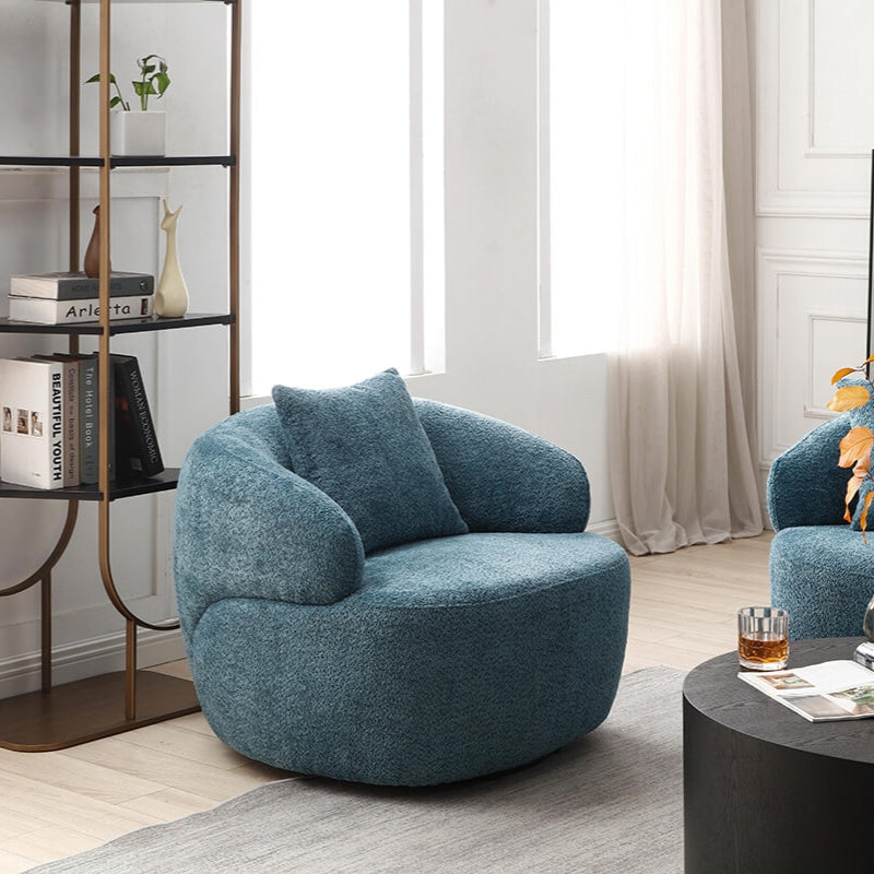 Light blue curved mid-century swivel sofa in a cozy living room setting.