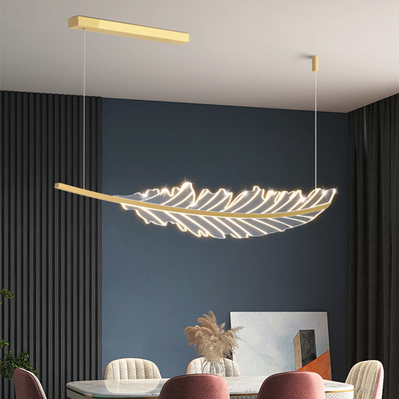 Close-up view of the gold leaf pendant lamp, highlighting the brushed gold finish and LED lights.