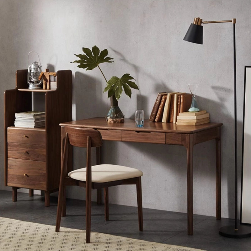 Close-up of the walnut desks smooth finish and drawer details, highlighting its quality craftsmanship.