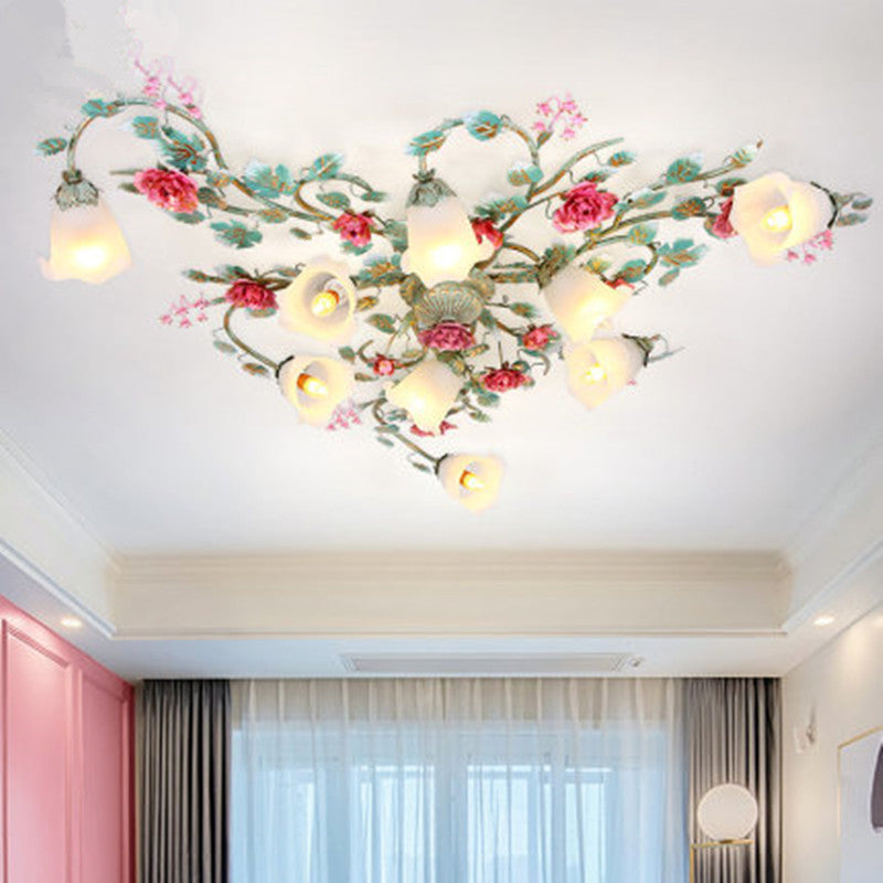Close-up of Rustic Rose Lantern Flush Mount Ceiling Light highlighting the intricate iron details.
