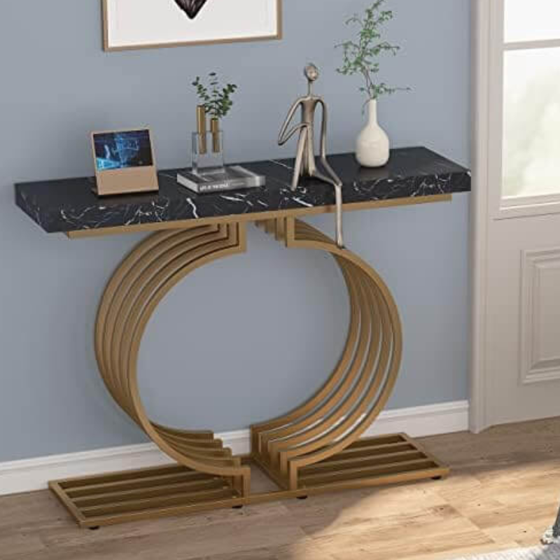 Stylish accent table behind a sofa with magazines and a lamp