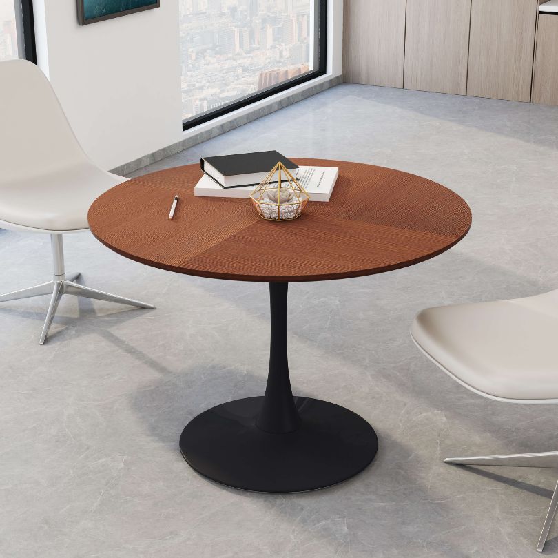 Elegant round oak dining table showcasing smooth tabletop and sturdy black legs.