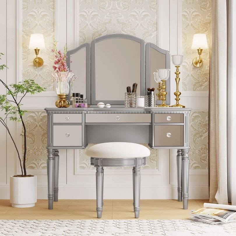 Elegant silver dressing table with tri-fold mirror from a side angle