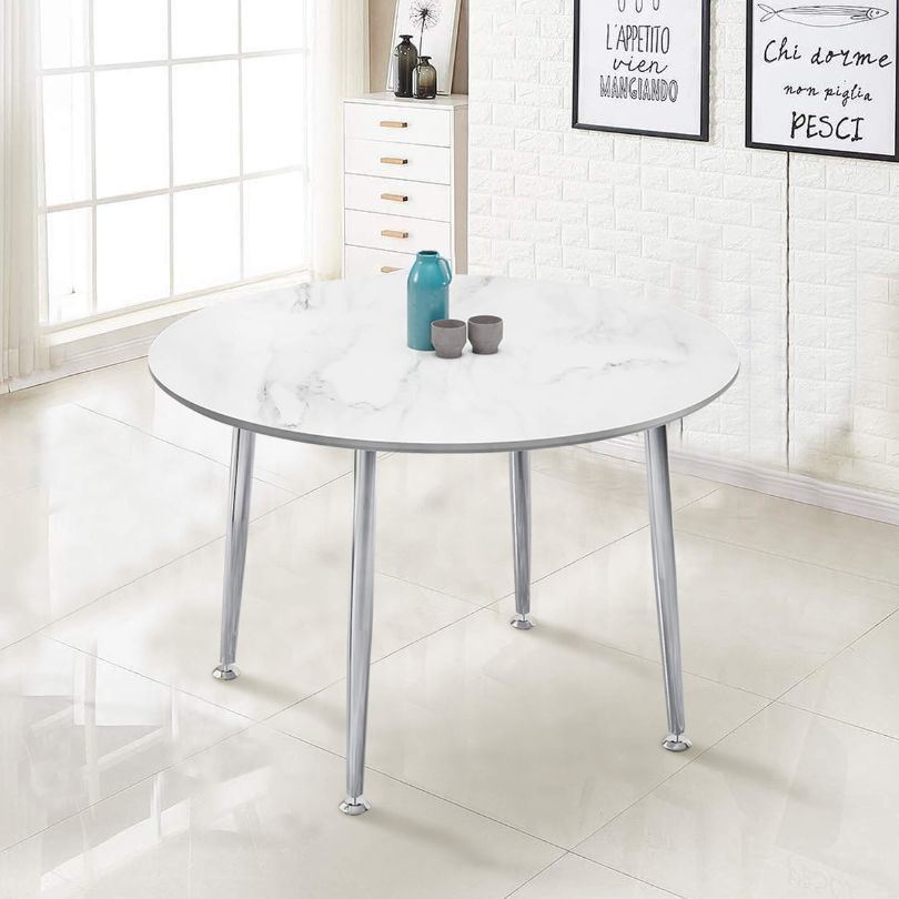 Front view of the stylish white round dining table with chrome legs.