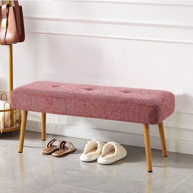 Close-up of the pink benchs linen texture and metal leg details, illustrating its quality and style.