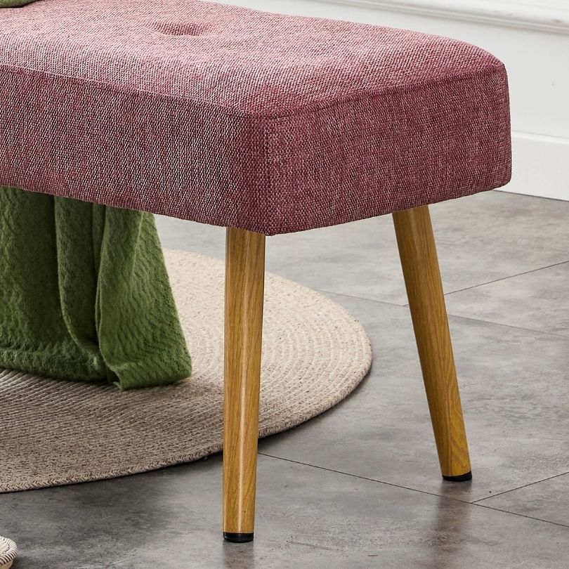 Side angle of the modern pink upholstered bench, highlighting its soft fabric and sturdy construction.
