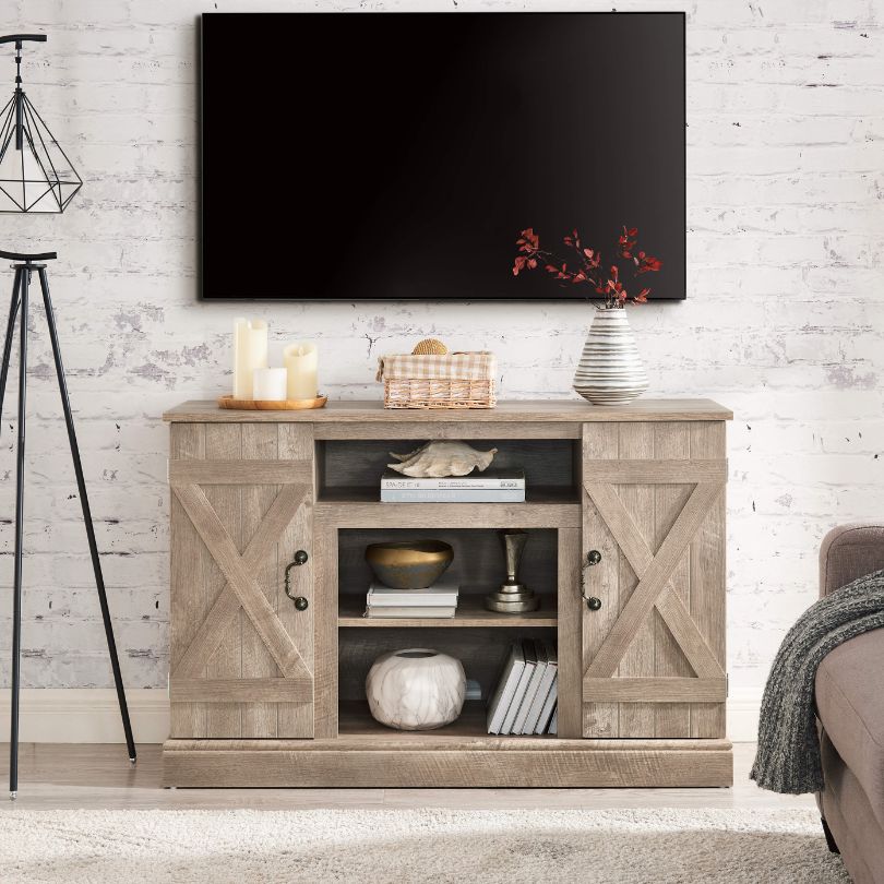 Front view of the gray wooden TV console with open storage space