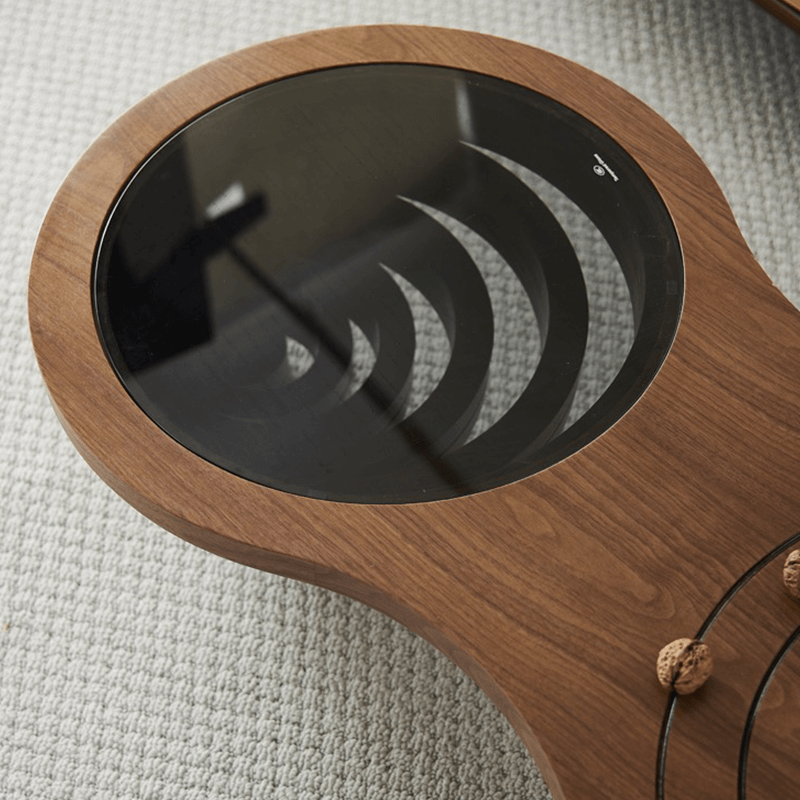 Close-up of the ashwood texture and orbit-like carvings on the Charming 47-Inch Rustic Coffee Table.