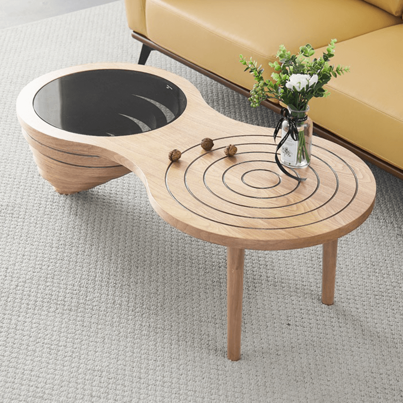 Close-up of the ashwood texture and orbit-like carvings on the Charming 47-Inch Rustic Coffee Table.