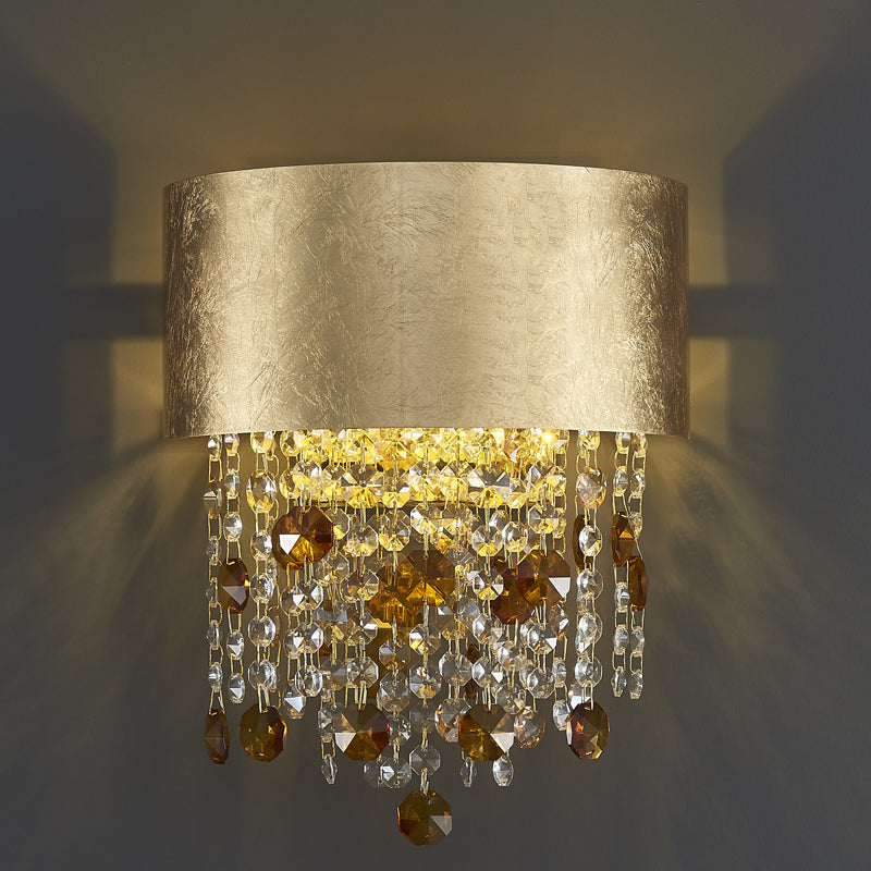 Elegant gold crystal teardrop wall sconce showcasing its luxurious design in a modern dining room.
