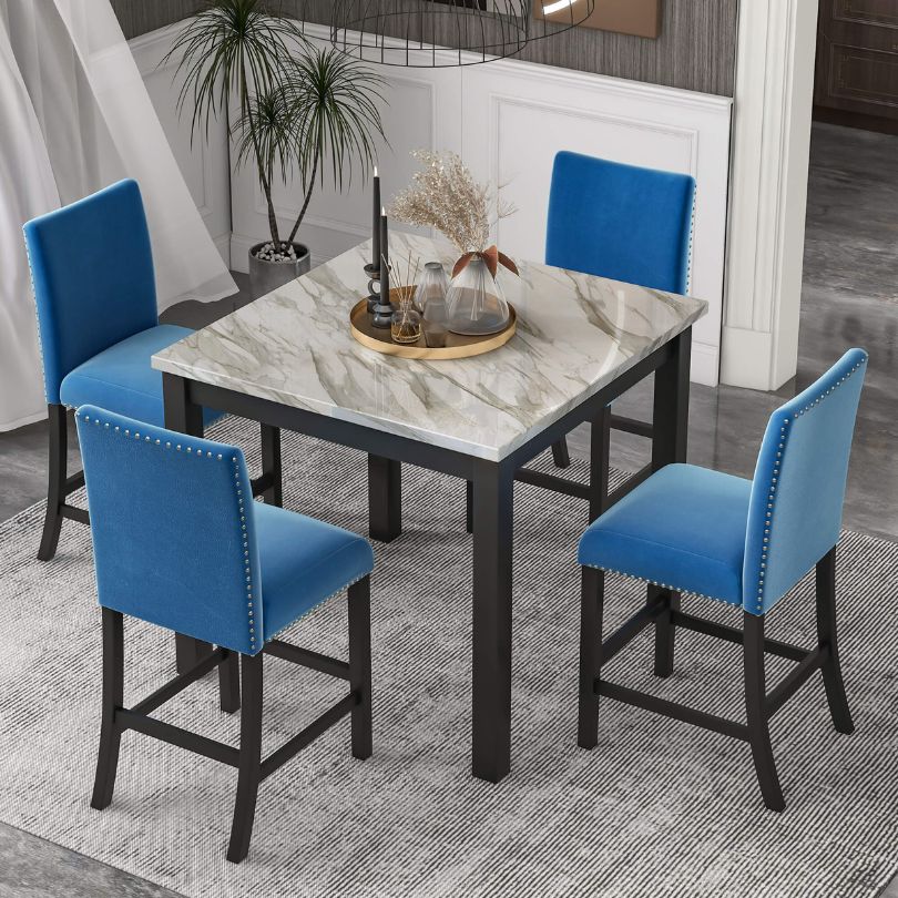 Cozy dining area with a 5-piece dining table set featuring a square faux marble table and blue chairs, perfect for small spaces.