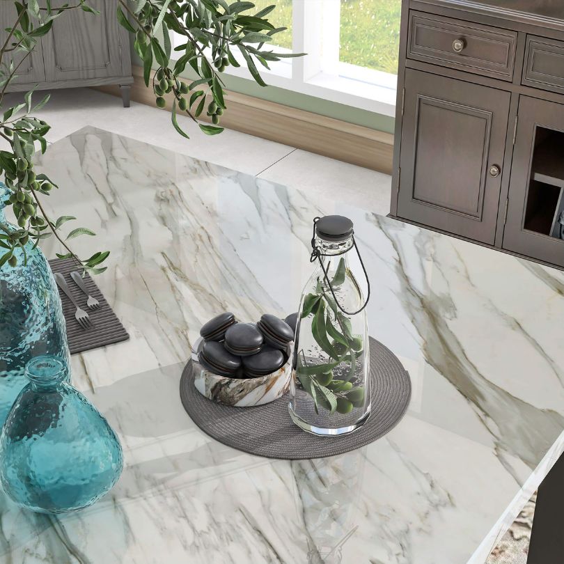Close-up of the stylish blue upholstered chairs paired with a sturdy faux marble dining table in a modern kitchen setting.