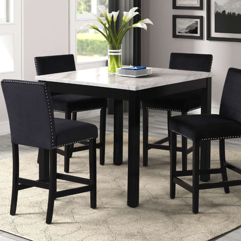 Elegant counter height dining table set with faux marble top and black chairs, ideal for family meals and gatherings.