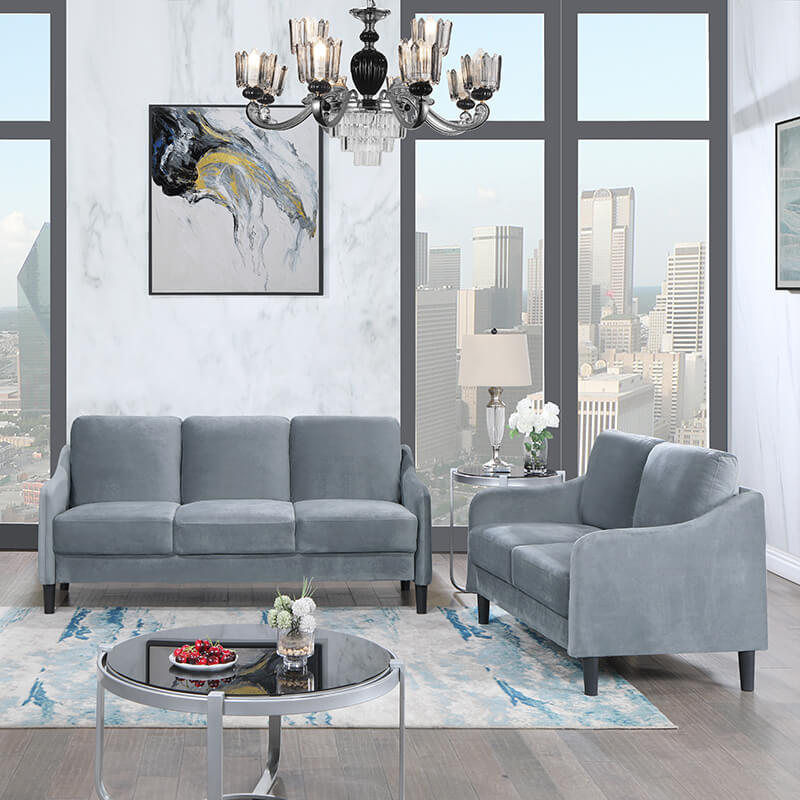 Chic gray upholstered loveseat in a cozy living room setting, showcasing its modern design.