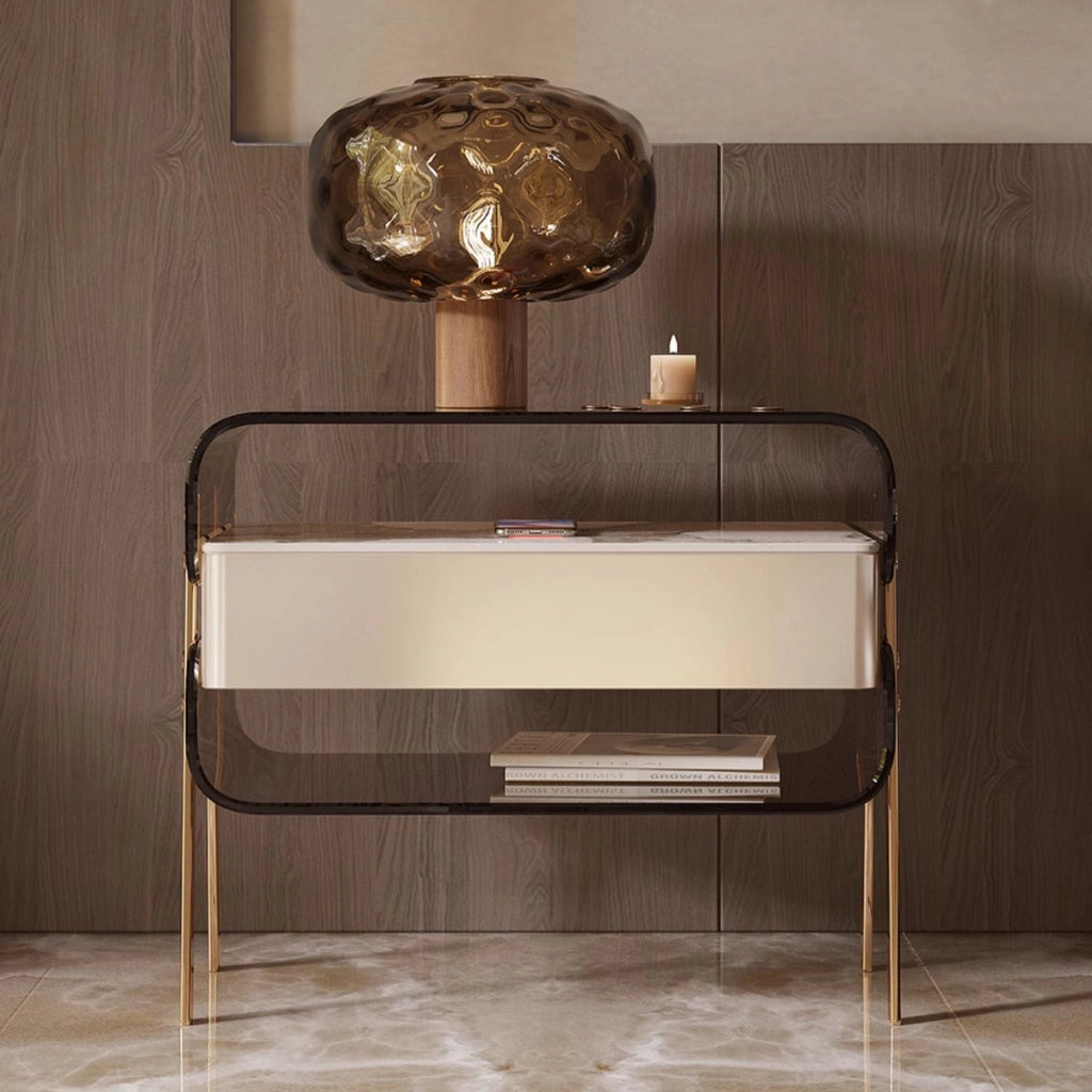 Side angle of modern acrylic nightstand with stainless steel legs and drawer.