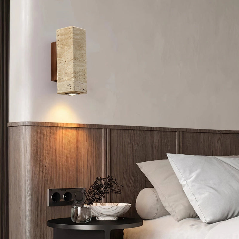 Elegant Japanese travertine wall lamp illuminated in a cozy outdoor setting, enhancing the ambiance.