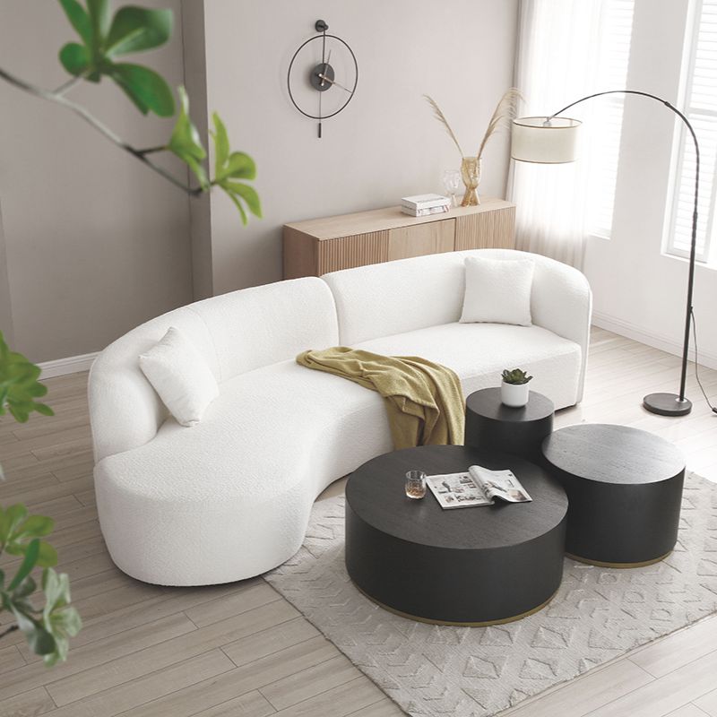 Stylish arrangement of the curved sofa in a cozy home office.