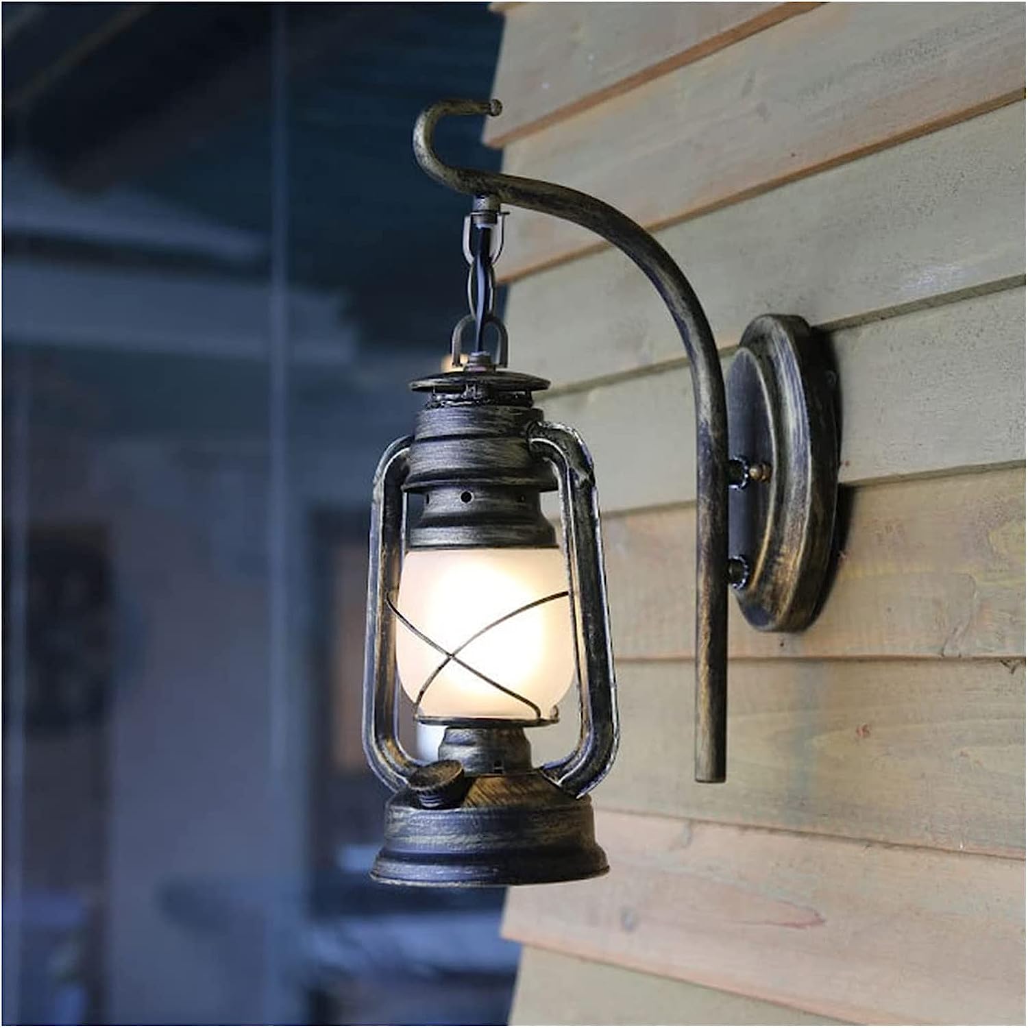 Rustic Vintage Barn Lantern Wall Light illuminating a stylish cafe interior.