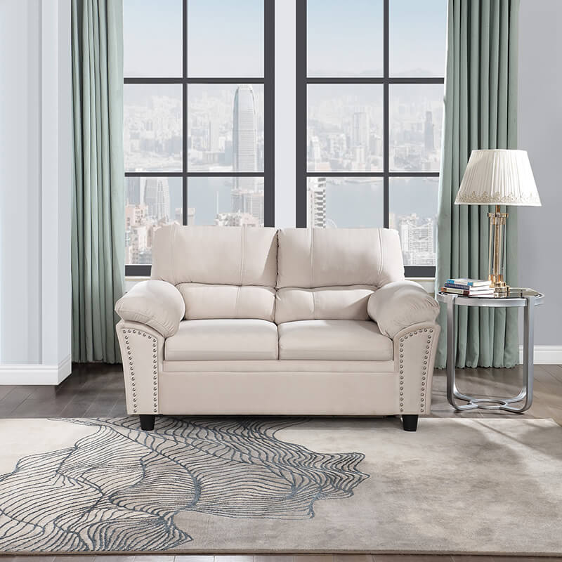 Front view of the beige upholstered sofa showing its velvet texture and sleek design