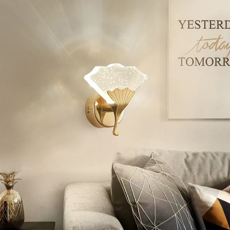 The elegant ginkgo leaf wall sconce mounted in a cozy entryway, providing ambient lighting.