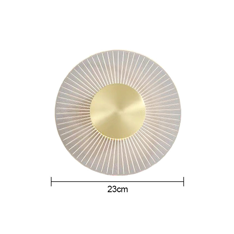 Modern wall sconce installed in a cozy bedroom, providing warm illumination.
