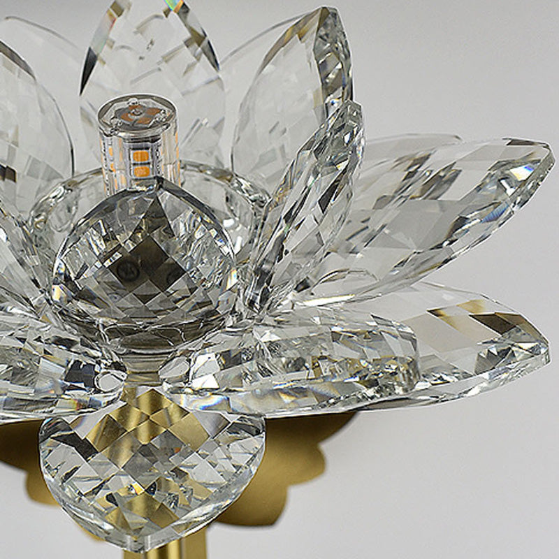 Close-up view of the clear glass shade of the Lotus Crystal Wall Lamp, highlighting its exquisite design.