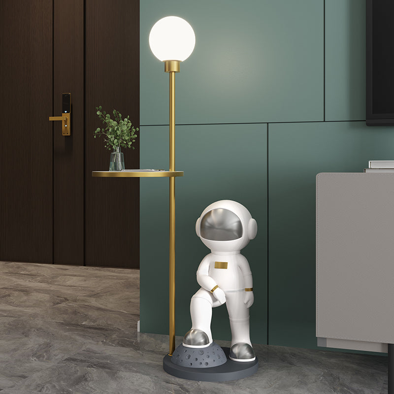 Astronaut floor lamp in a cozy living room setting, highlighting its decorative features.