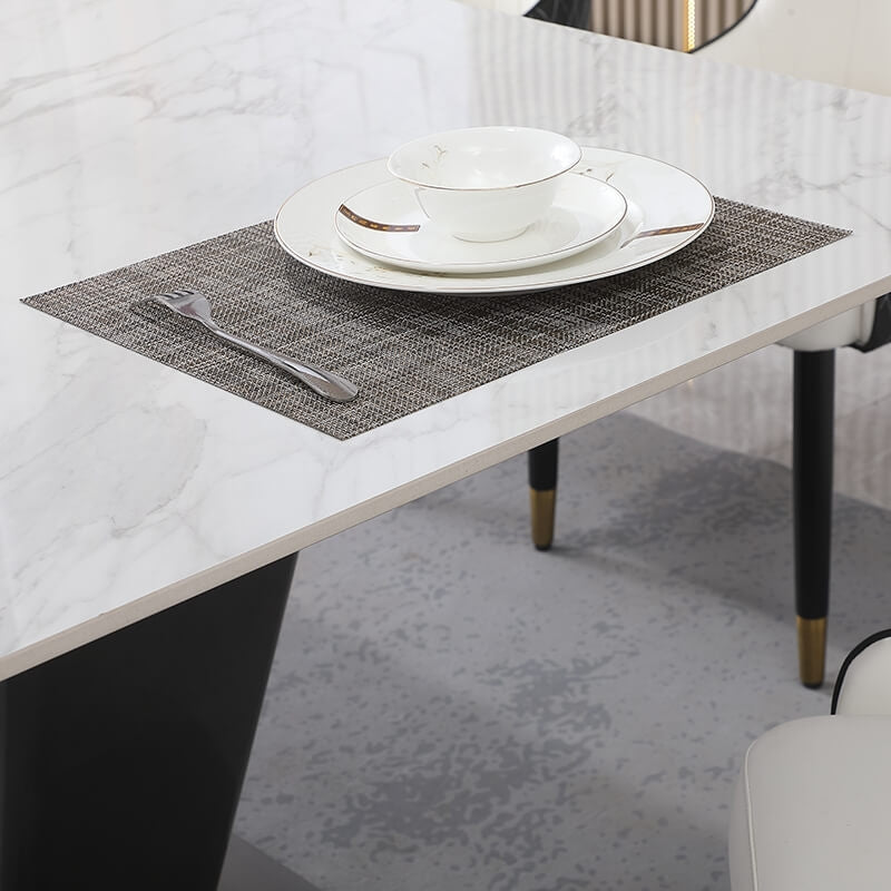 Modern dining table set with sintered stone top and gold V-shape base, showcasing family dining.