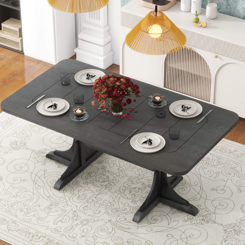 Side view of the modern black dining table with pedestal base, showcasing its sleek design and sturdy construction.
