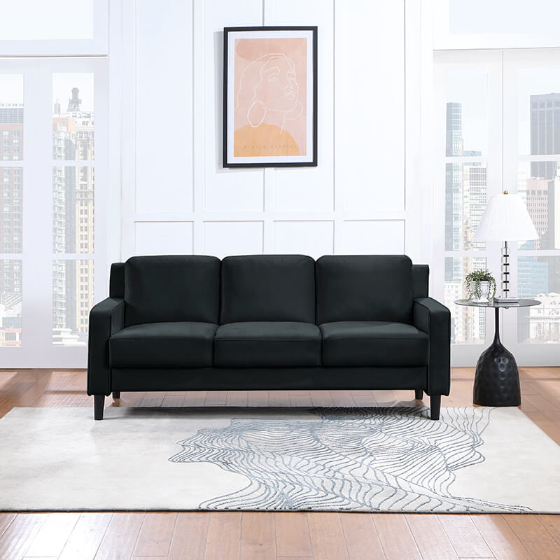 Luxurious modern velvet black 3-seater sofa in a stylish living room setting.