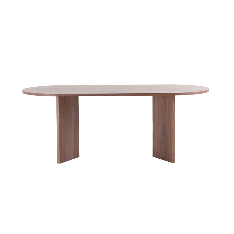 Close-up view of the walnut wood grain and structural buckle of the farmhouse dining table.