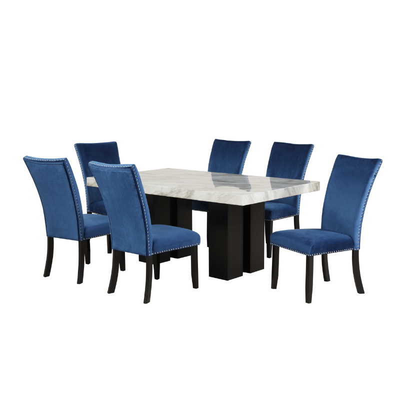 Luxury faux marble dining table set with blue velvet chairs from an angled view.
