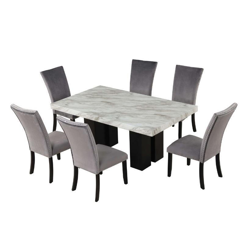 Close-up view of the gray velvet chairs around the faux marble dining table highlighting the textures.