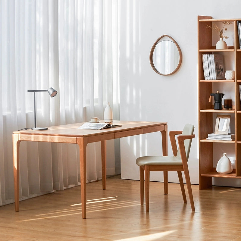 Cherry wood writing desk with drawers, showcasing sleek Scandinavian design.